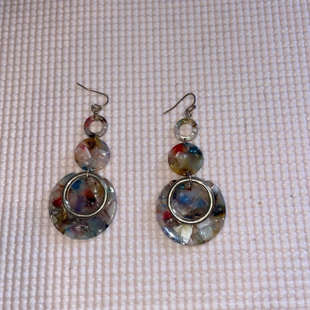 Long dangling acrylic earrings.